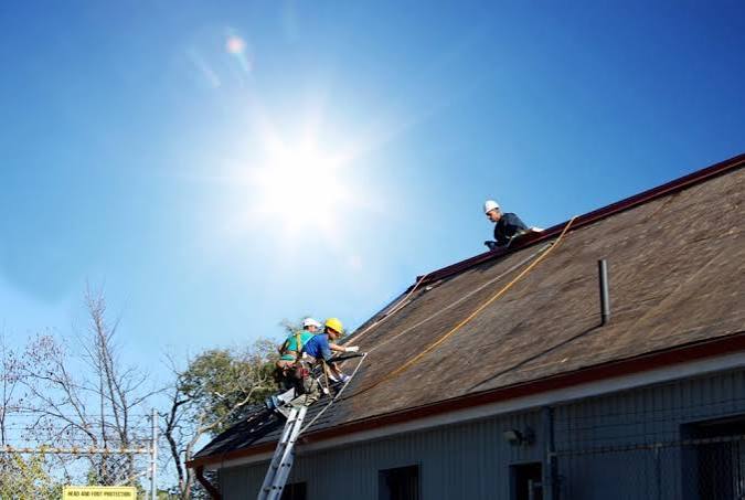 Roofers working in the blazing hot sun during the summertime